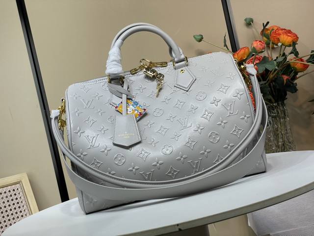 Exclusive photo of the original Speedy Soft 30 handbag, M25670, in gray embossed