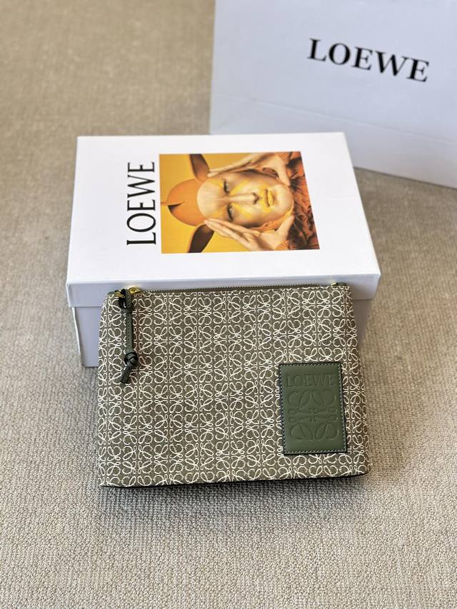 Loewe's new canvas clutch. This 100go canvas clutch features a widened base for