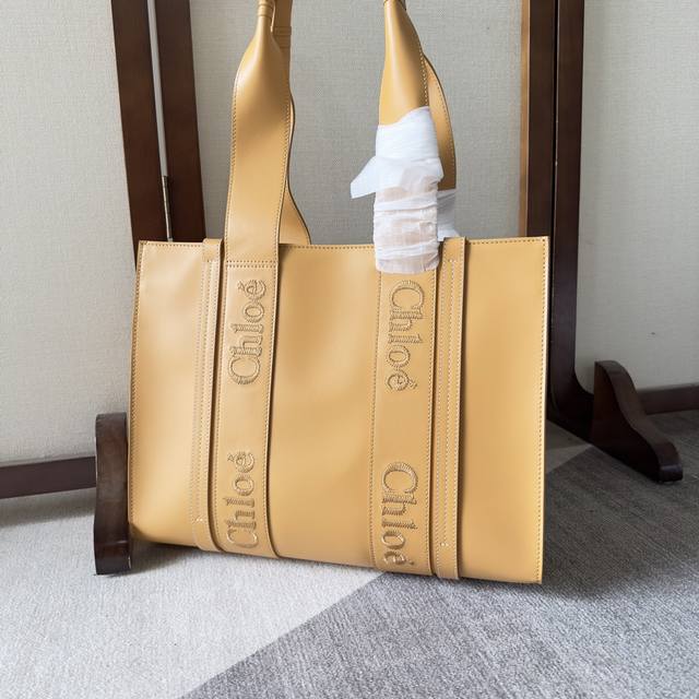 Chloe Woody Tote皮质产品细节 光滑小牛皮托特包，饰Chloé标识刺绣 Woody托特包采用自然质感光面小牛皮制成，演绎独特的奢华感受。这是一款富
