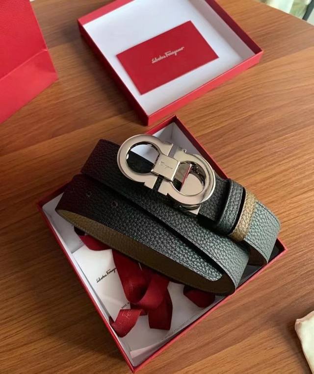 Gift This stylish double-sided belt from Salvatore Ferragamo features a two-tone Gift This stylish double-sided belt from Salvatore Ferragamo features a two-tone