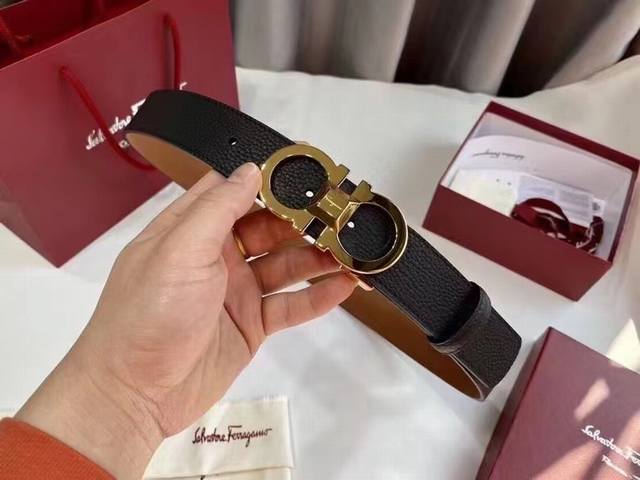 Gift This stylish double-sided belt from Salvatore Ferragamo features a two-tone Gift This stylish double-sided belt from Salvatore Ferragamo features a two-tone