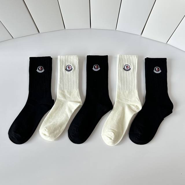 Special packaging for Moncler's latest mid-calf embroidered slouch socks! Five p