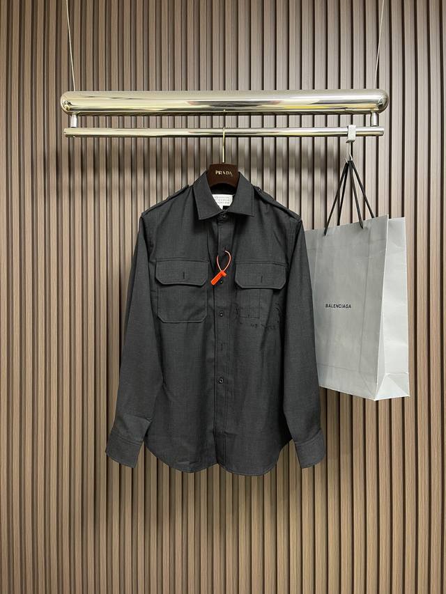 Mm6 This custom-made wool long-sleeved shirt jacket features a fine wool blend t Mm6 This custom-made wool long-sleeved shirt jacket features a fine wool blend t