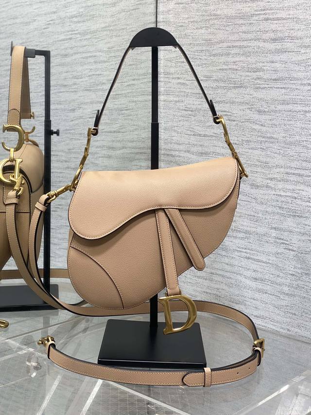 The classic saddle bag with a deep apricot color and long shoulder strap is the The classic saddle bag with a deep apricot color and long shoulder strap is the