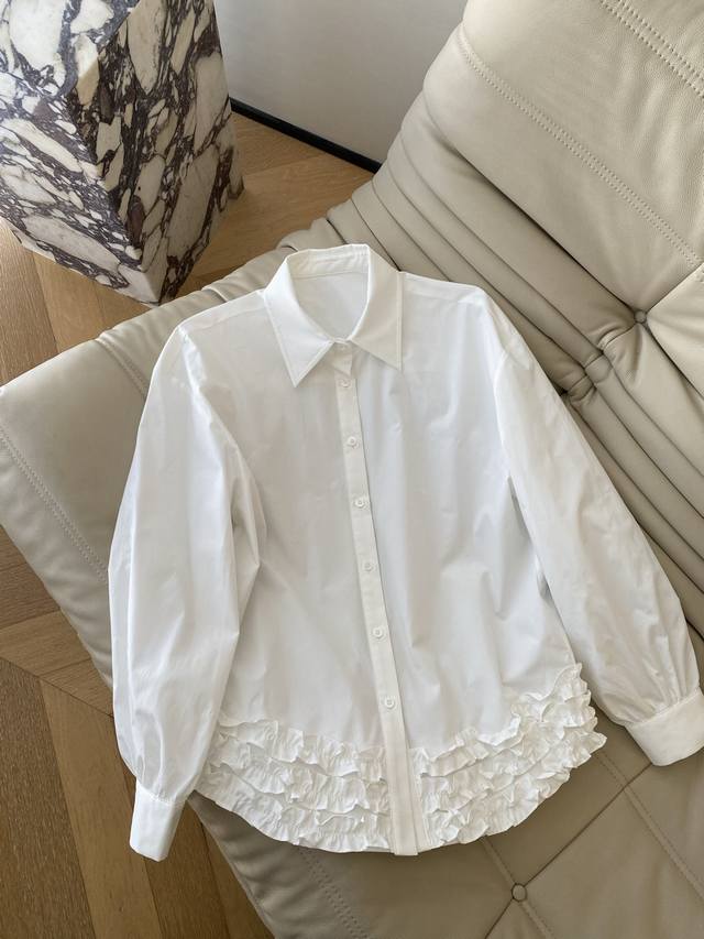 26Ss This early spring new white shirt features a ruffled hem that's the perfect 26Ss This early spring new white shirt features a ruffled hem that's the perfect