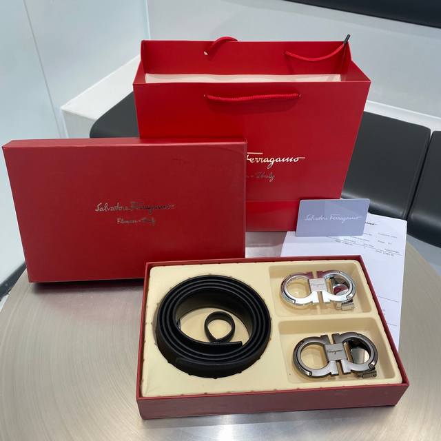 A classic Ferragamo men's belt with a figure-eight buckle and full packaging. In