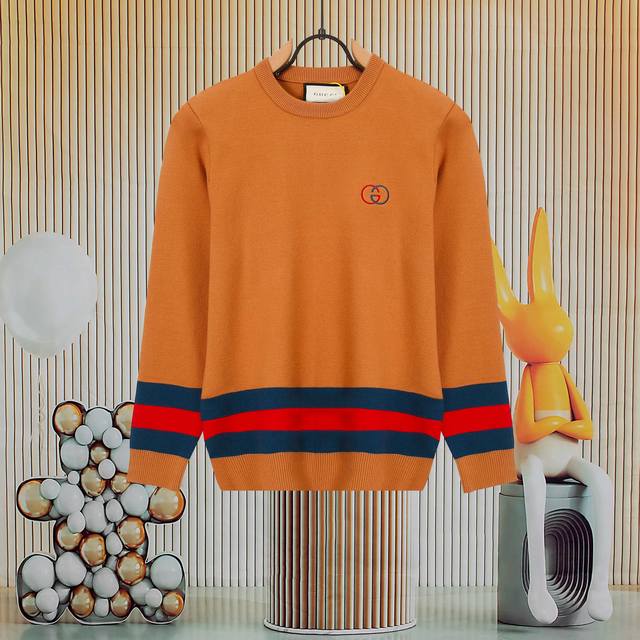 A popular Gucci striped crew neck knit sweater with an embroidered logo on the f