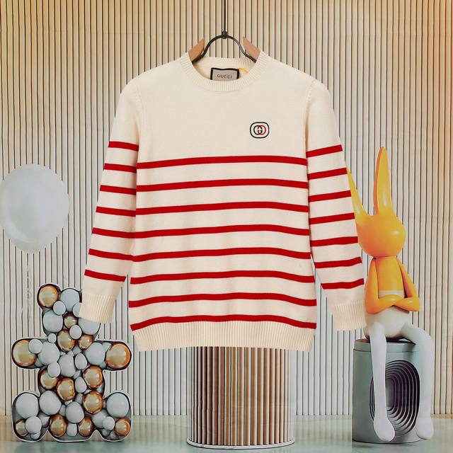 A popular Gucci striped crew neck knit sweater. The logo on the front is embroid