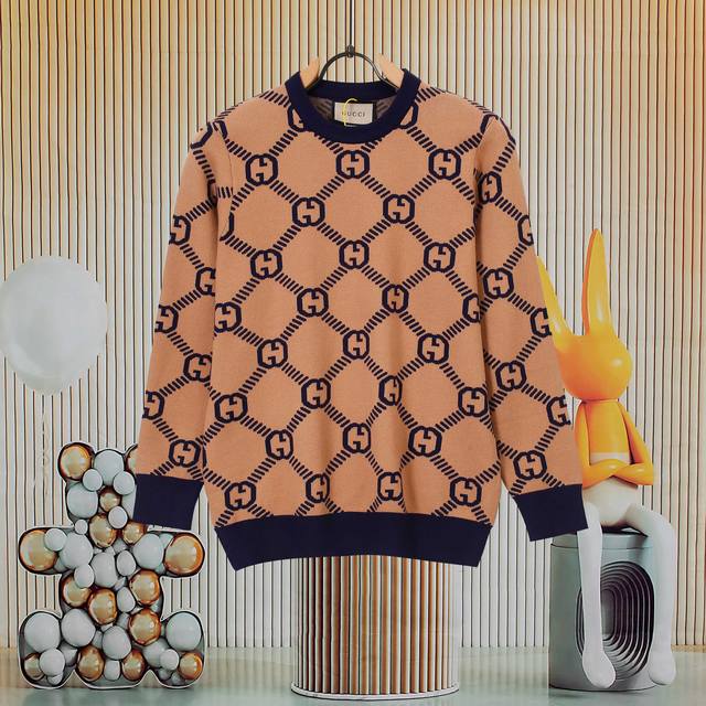 A popular Gucci all-over logo knit sweater with royal blue ribbed details at the