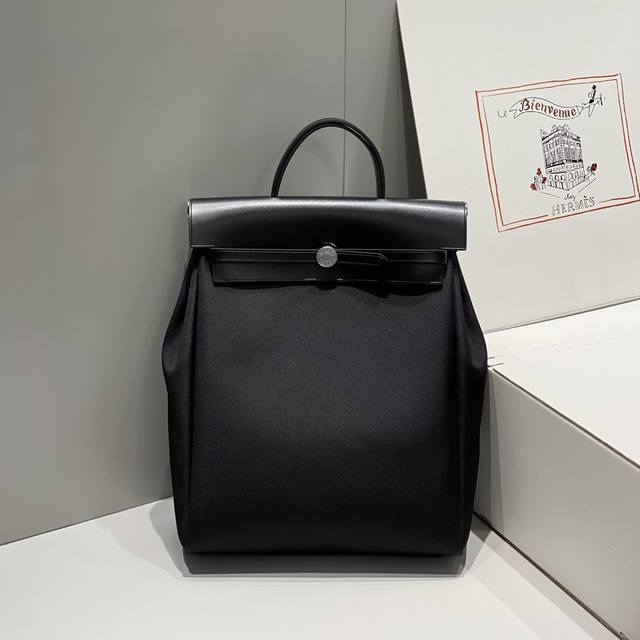 Black Herbag A Dos Zip Canvas Backpack. The design is versatile and flattering,