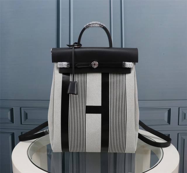 Black H Herbag A Dos Zip Canvas Backpack. The design is versatile and flattering