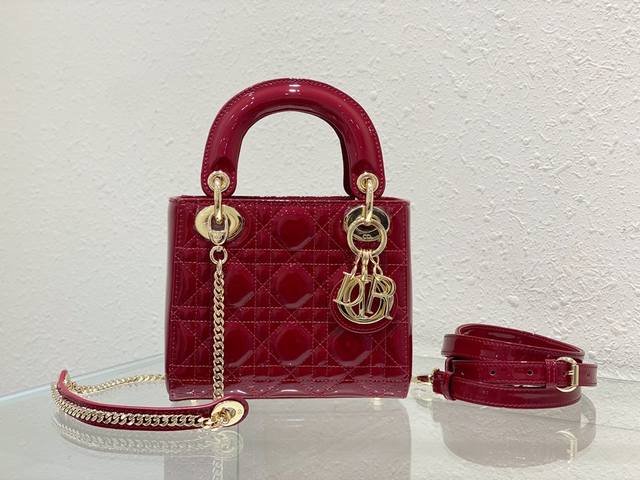 A three-compartment cherry red patent leather Lady Dior handbag, a masterpiece e