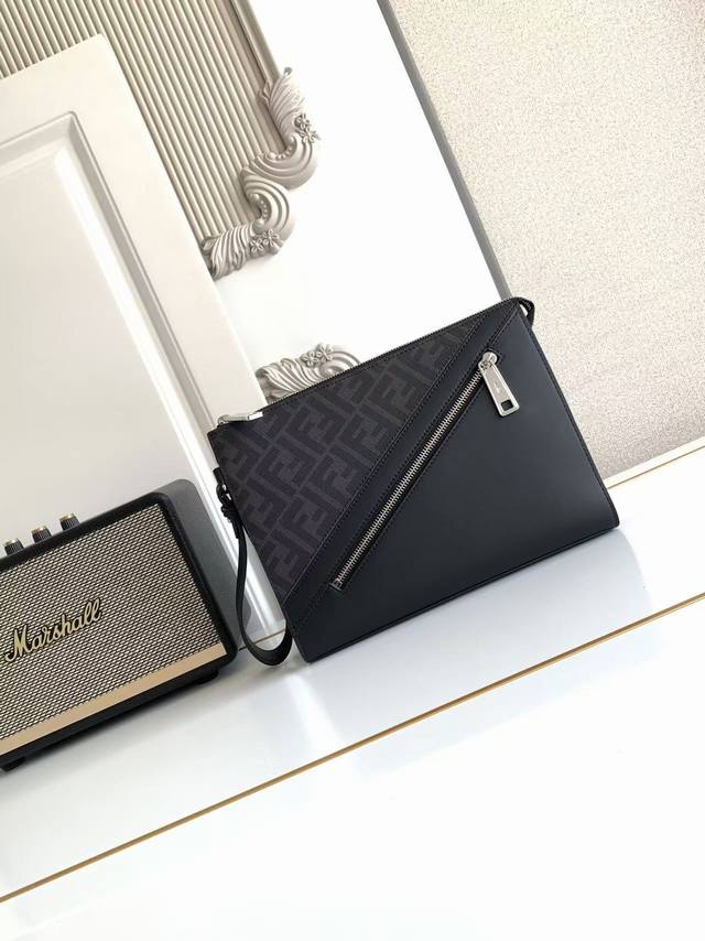 This clutch features a detachable chain handle, an interior card holder, and a f