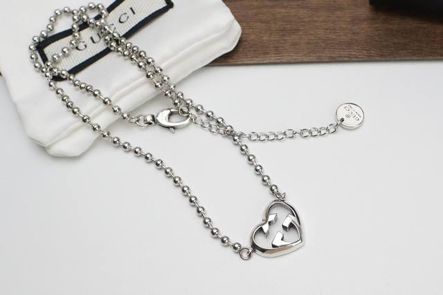 Gucci Double G Heart Interlocking Bracelet Necklace. The classic double G logo d
