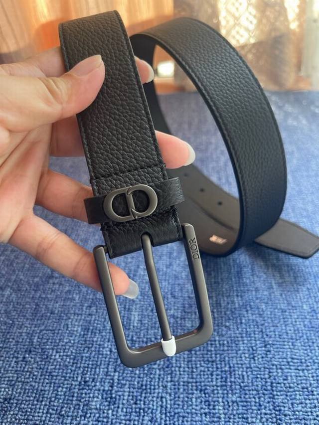 55095 is meticulously crafted from black grained calfskin leather, featuring a D