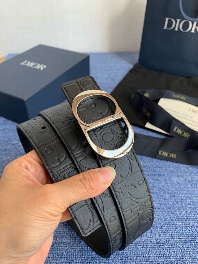 这款 35 毫米双面腰带结合典雅气质与摩登风范。 55095。 配一面采用黑色 Dior Gravity 印花效果皮革，以牛皮革融合压花工艺，演绎经典的 Obl