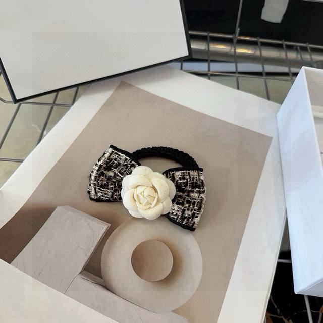 comes with a Chanel hair tie in its latest packaging box. A chic and fashionable