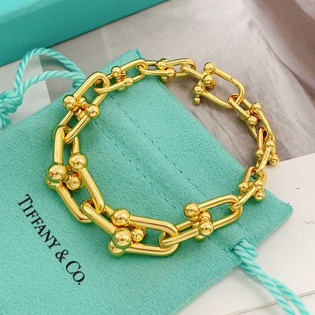 Tiffany's latest gold U-shaped horseshoe clasp bracelet, varying in size, made o
