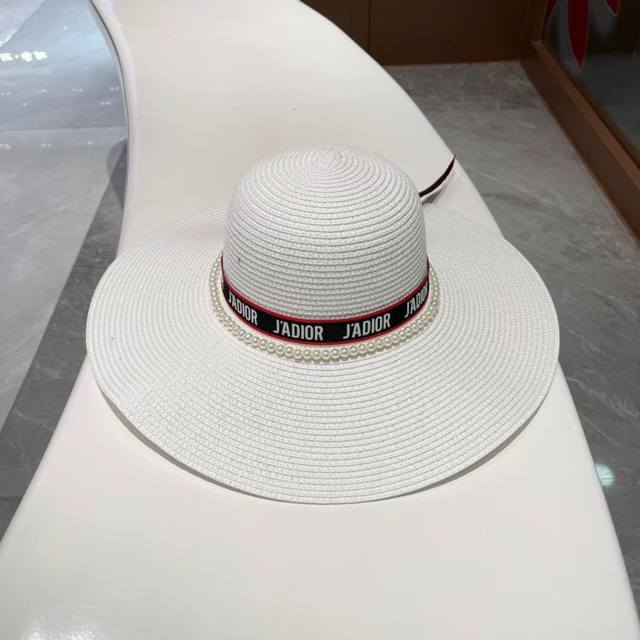 Dior's new wide-brimmed straw hat with ribbon and pearl trim, perfect for the be