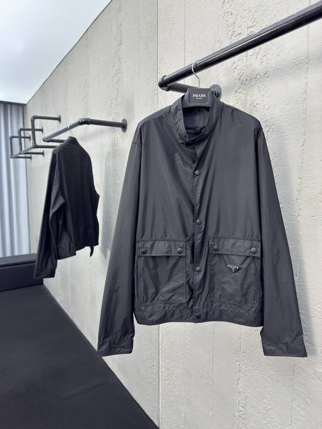 Prada Recycled Nylon Triangle Logo Jacket. Craftsmanship: Features a stand-up co