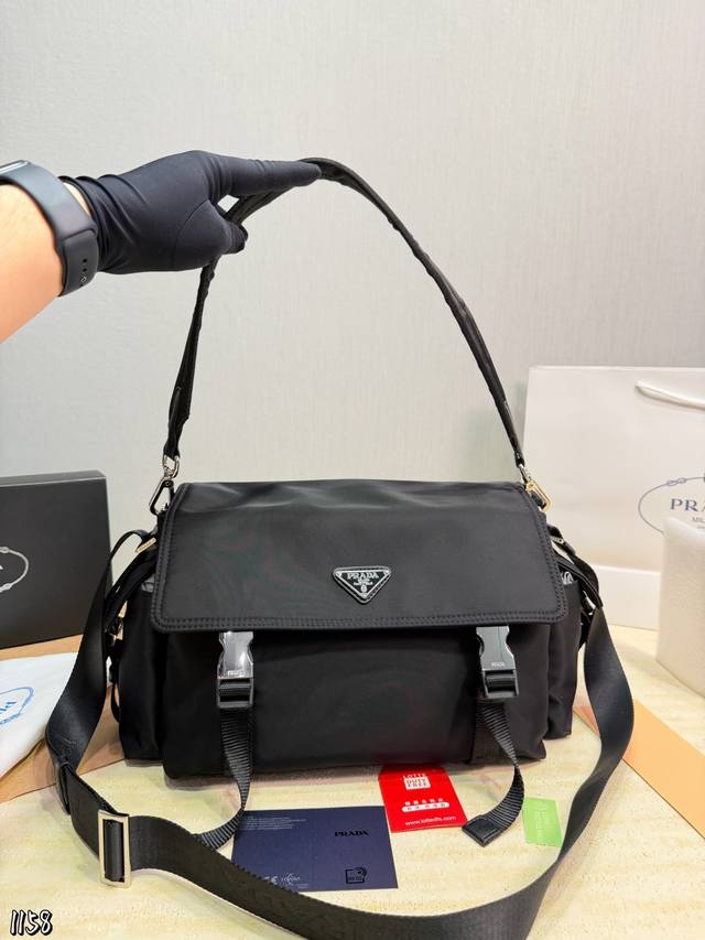 This Prada nylon messenger bag/motorcycle bag is made of classic black nylon, pa This Prada nylon messenger bag/motorcycle bag is made of classic black nylon, pa
