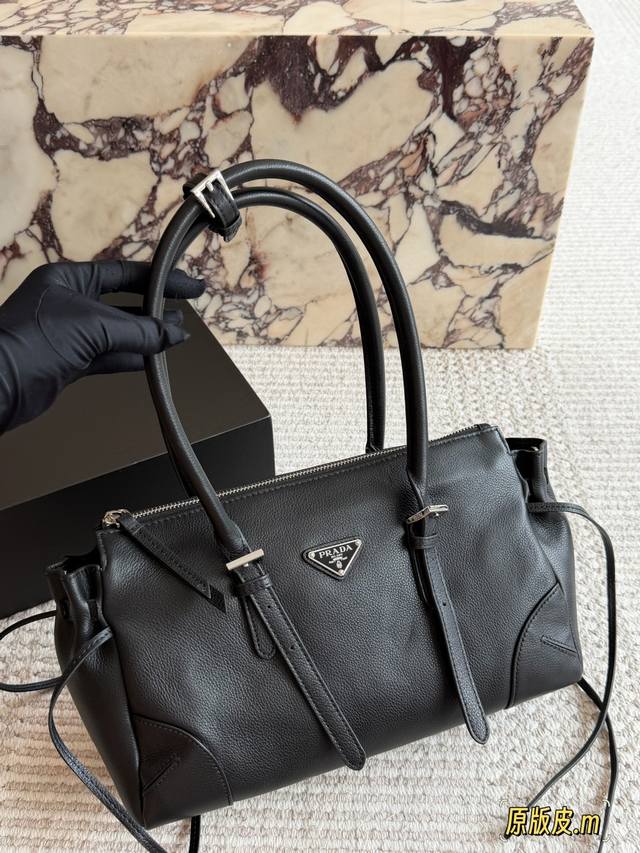 Prada Bonnie Handbag. Made of supple calfskin and featuring the iconic triangula Prada Bonnie Handbag. Made of supple calfskin and featuring the iconic triangula