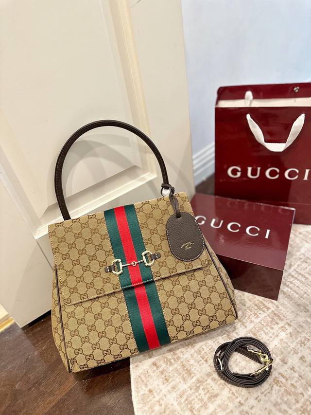 Gucci Gg Pasarazzo Vintage Handbag blends classic Gucci elements: monogram canva Gucci Gg Pasarazzo Vintage Handbag blends classic Gucci elements: monogram canva