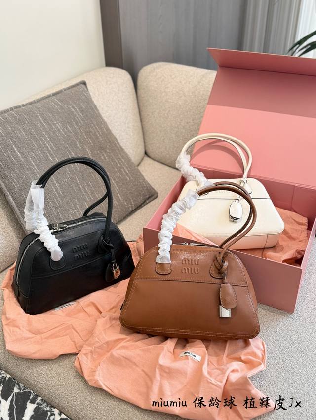 Miu Miu Vivant Bowling Bag This Miu Miu Vivant bowling bag features a classic sh