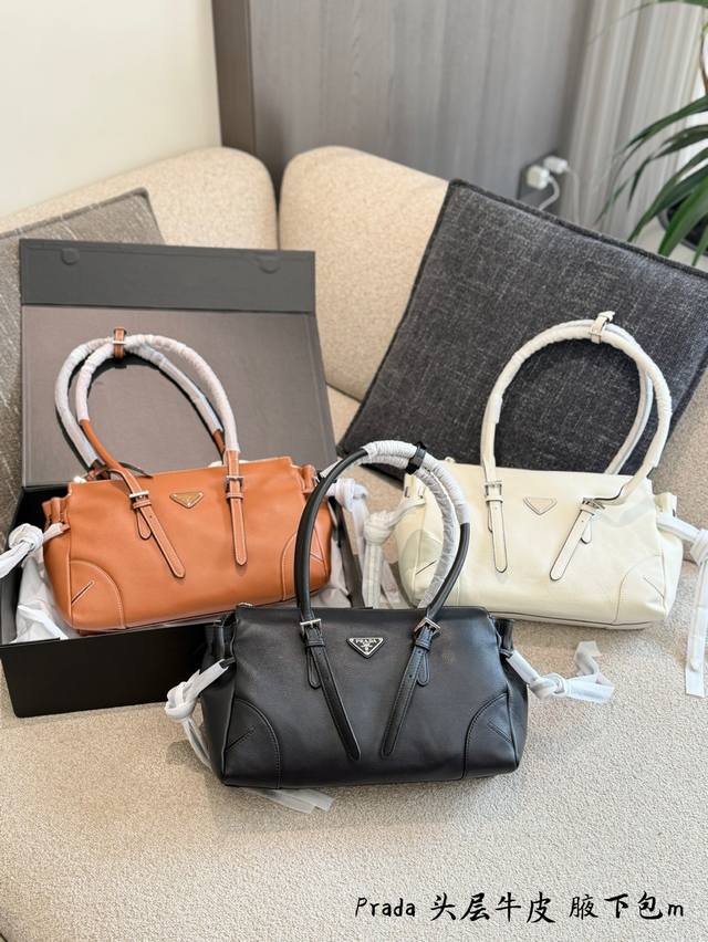 Prada Bonnie Handbag. Made of supple calfskin and featuring the iconic triangula