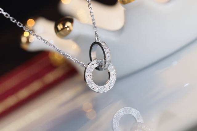 A stunning Cartier Love necklace, a classic double-ring design with full diamond A stunning Cartier Love necklace, a classic double-ring design with full diamond