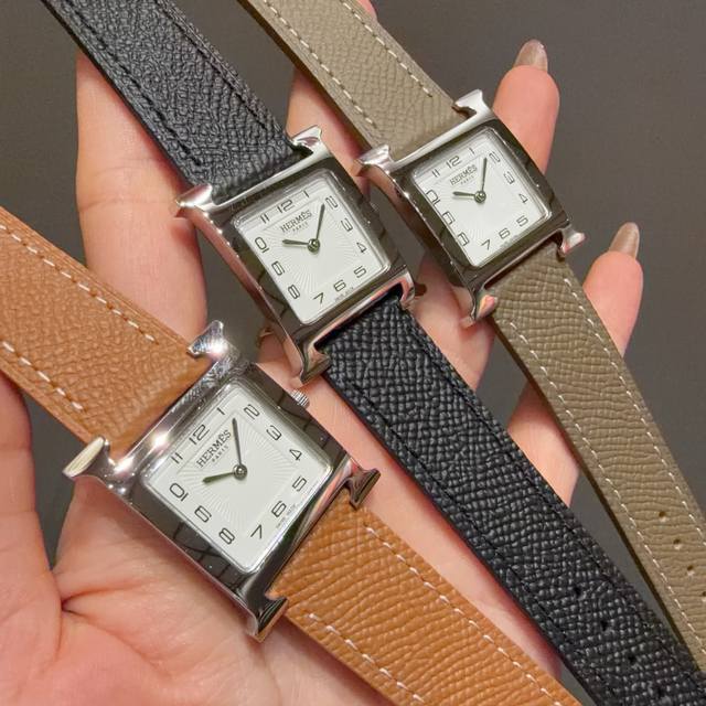 490 Hermes Heure H series, featuring a vibrant colored strap that wraps around t