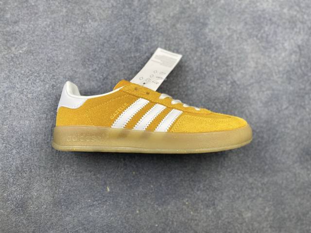 This is a pair of Adidas Gazelle Indoor sneakers in pink and white, commonly kno