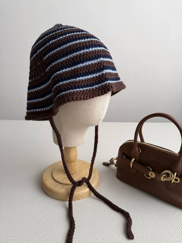 P340 Miumi* This striped woven hat is hand-crocheted with a three-color stripe d