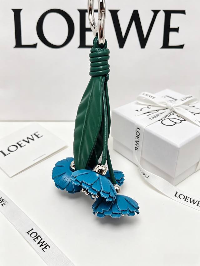 P90 Loewe blue leather flower charm, with clean petals and fresh green leaves, i