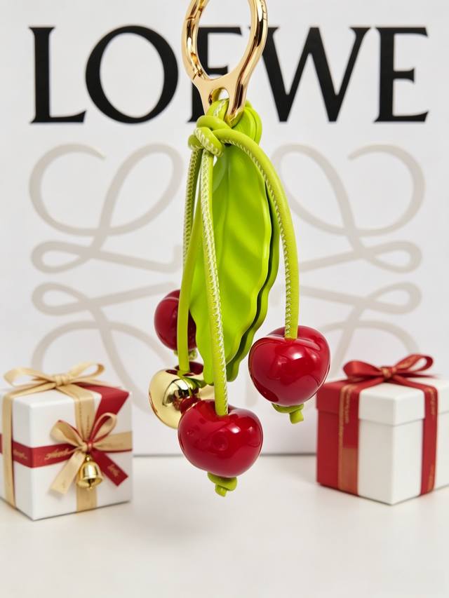 P90 Loewe apple charm, featuring vibrant red berries and fresh green leaves, bri