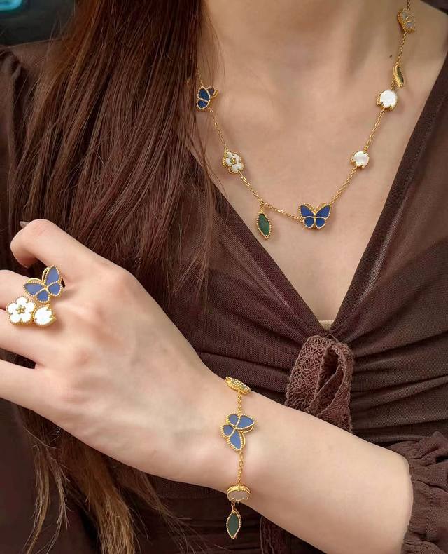 P750 V gold Vca plum blossom and butterfly sweater chain. The butterfly rests on