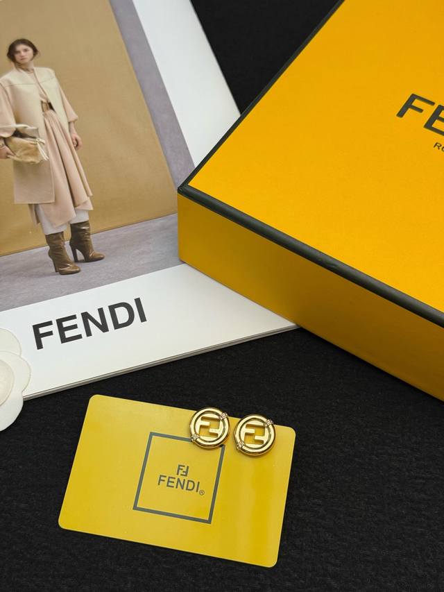 P70 Fendi Ff Logo Stud Earrings. Made of gold-plated metal, these Fendi Ff logo