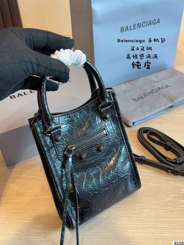 p280 This Balenciaga black mini motorcycle bag is made of distressed cracked lea
