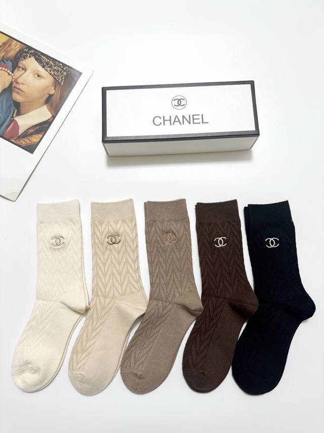 70 A box of 5 pairs of Chanel classic logo cashmere mid-calf socks with packagin