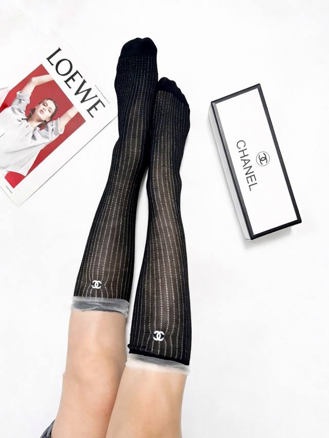 50 One pair of Chanel classic logo cutout knee-high socks, heavy-duty embellishm