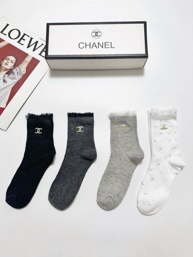 60 A box of 4 pairs of Chanel classic logo cotton mid-calf socks, including pack
