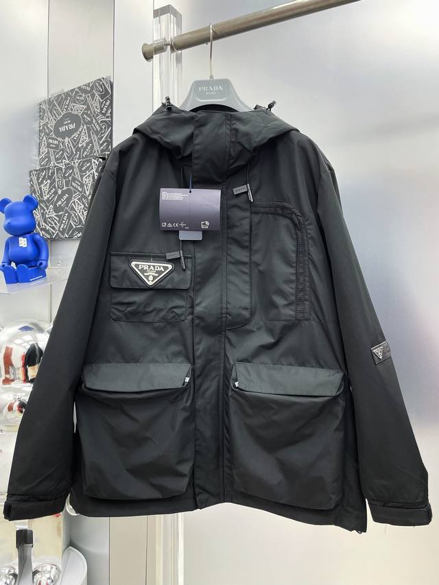 p420 pra*普拉达 2026Ss秋冬新款口袋拼接工装徽标连帽风衣外套 M 原单三标齐全高端版本 专柜定制面料 透气舒适度高，细节无可挑剔，品牌元素设计理