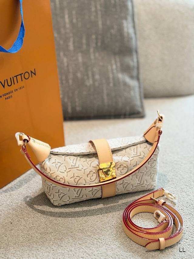 LV Pochette Mia Bento Bag p310 The LV Pochette Mia features Monogram Empreinte e
