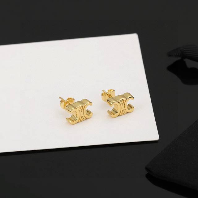 p50 Celine's new Triumph Pearl Earrings feature a unique and distinctive design