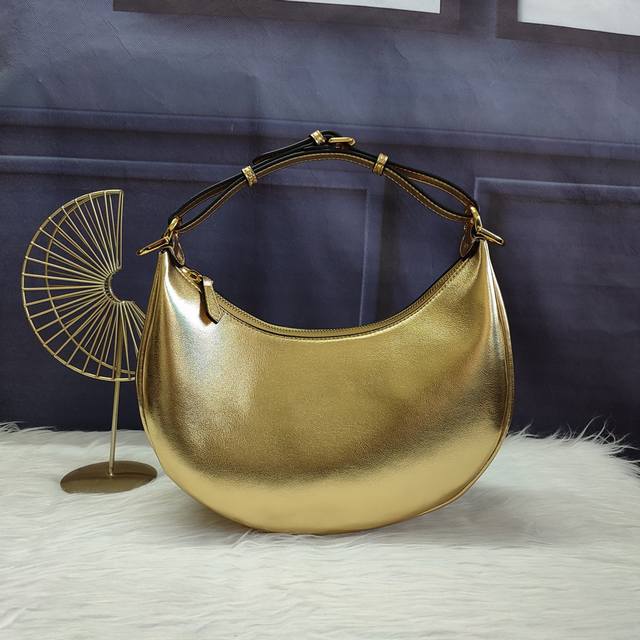 310, Style No. 8Br798, Crescent Bag, gold-colored, made of soft gold leather. Wh