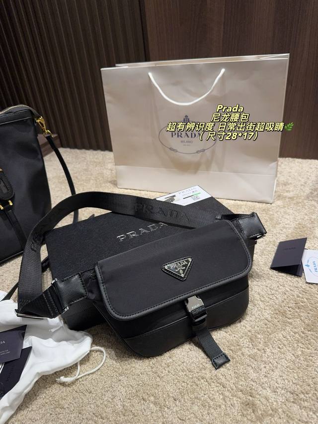 p200 (Box included) Size 28*17 mm. Prada nylon waist bag, black striped nylon wi p200 (Box included) Size 28*17 mm. Prada nylon waist bag, black striped nylon wi